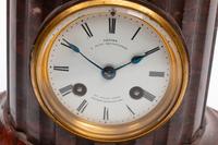 A French Patinated Bronze and Rouge Marble Figural Mantel Clock