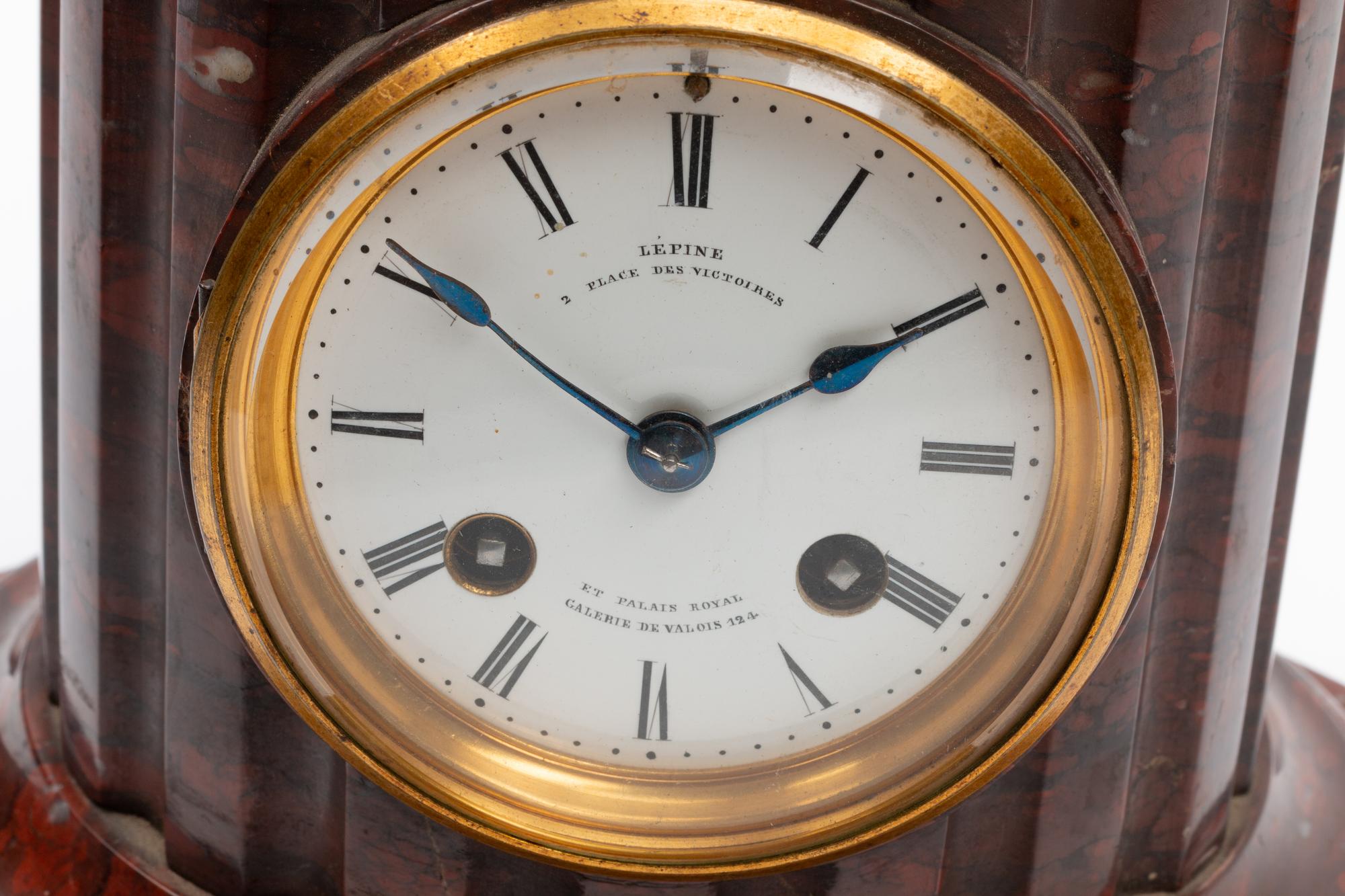 A French Patinated Bronze and Rouge Marble Figural Mantel Clock