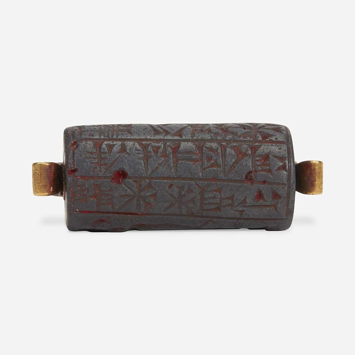 A Babylonian carved hematite cylindrical seal second millenium B.C.