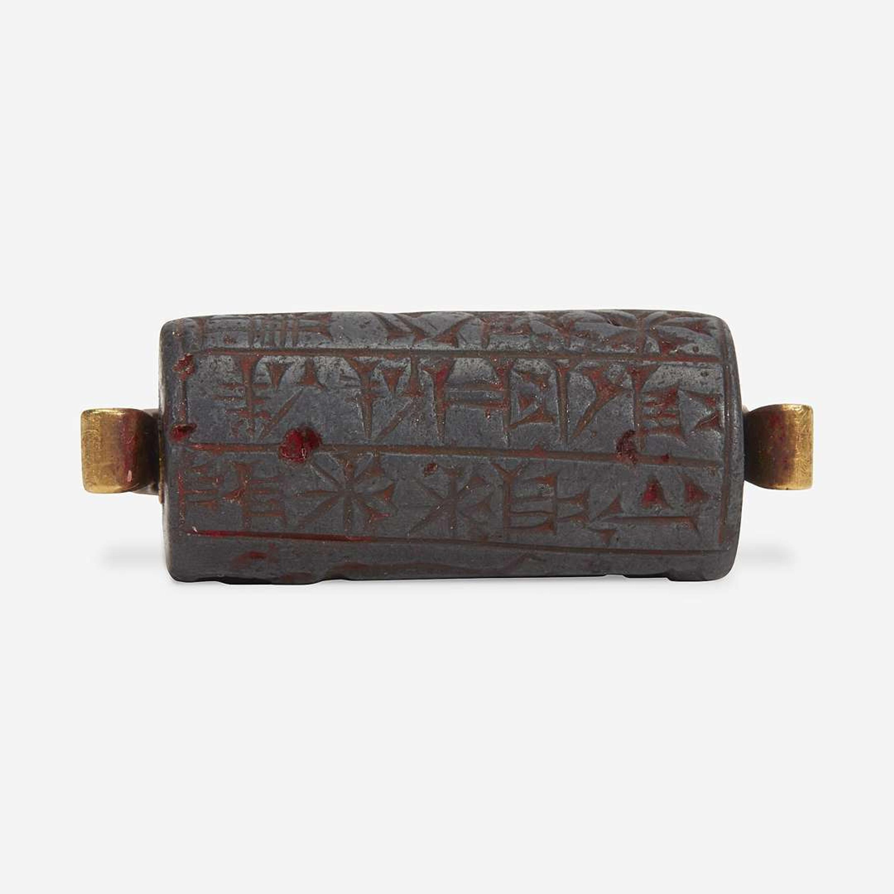 A Babylonian carved hematite cylindrical seal second millenium B.C.