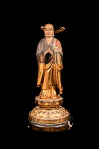 A Polychrome and Gilt Painted Wood Figure of a Standing Monk