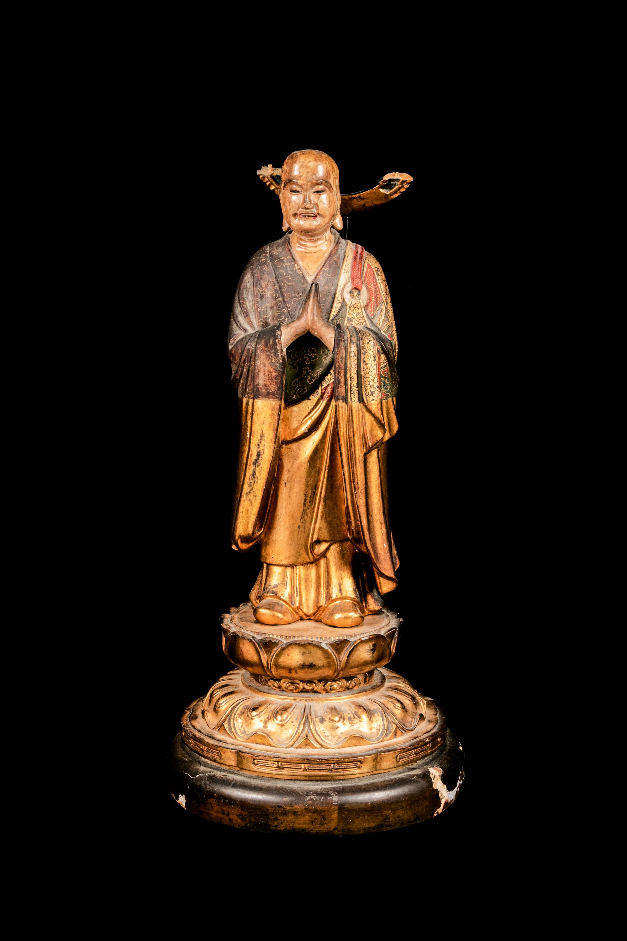 A Polychrome and Gilt Painted Wood Figure of a Standing Monk