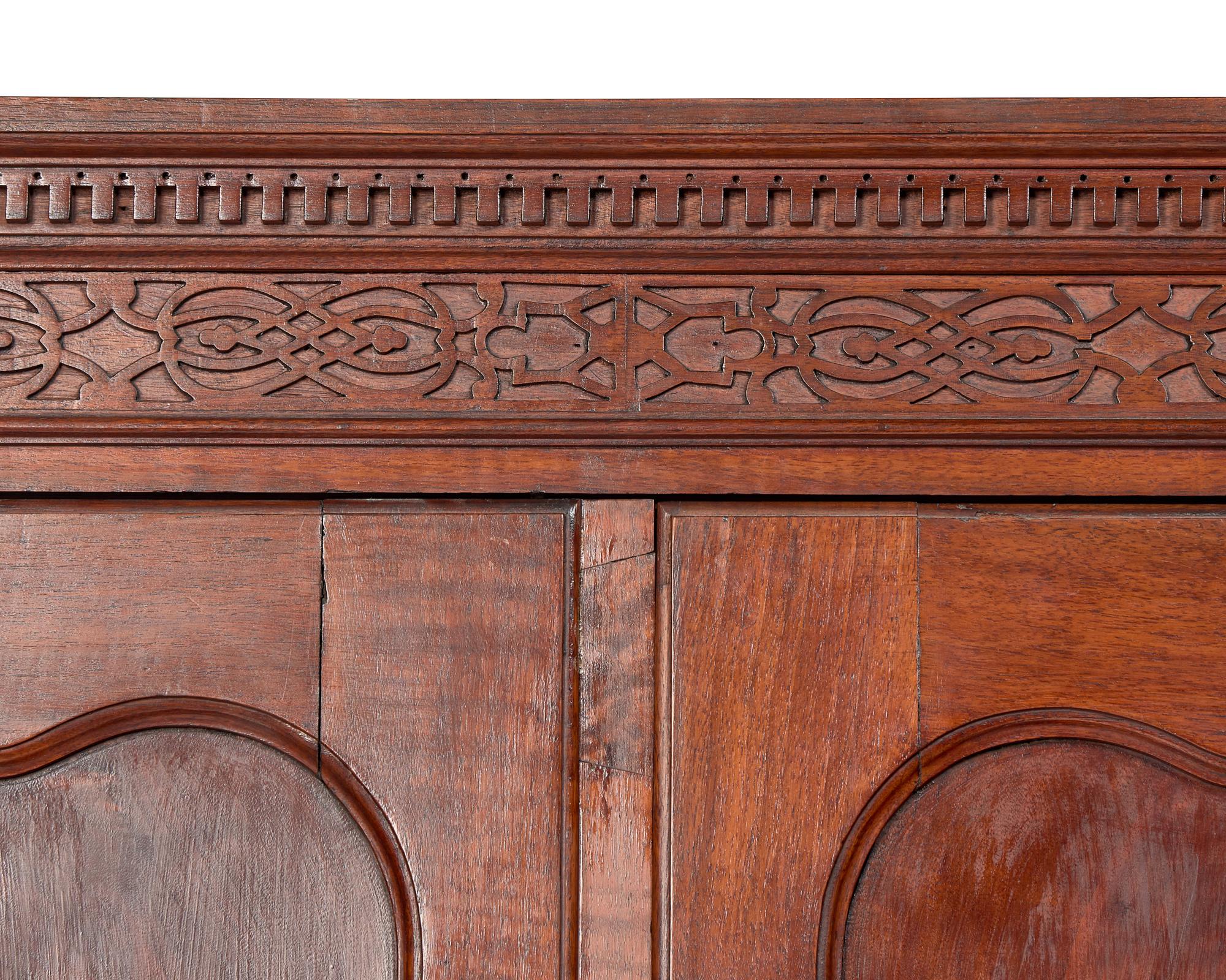 A Chippendale Figured and Carved Walnut Desk-and-Bookcase