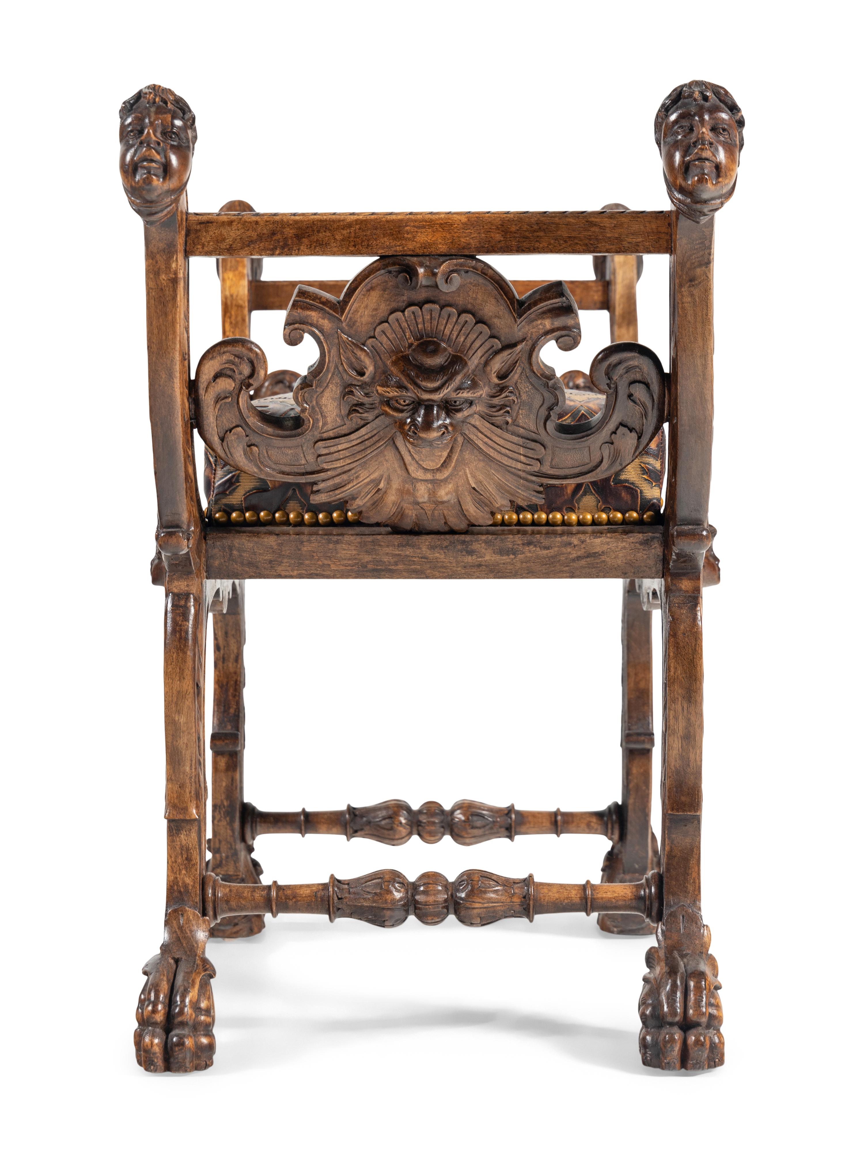 An Italian Renaissance Revival Carved Walnut Curule Bench