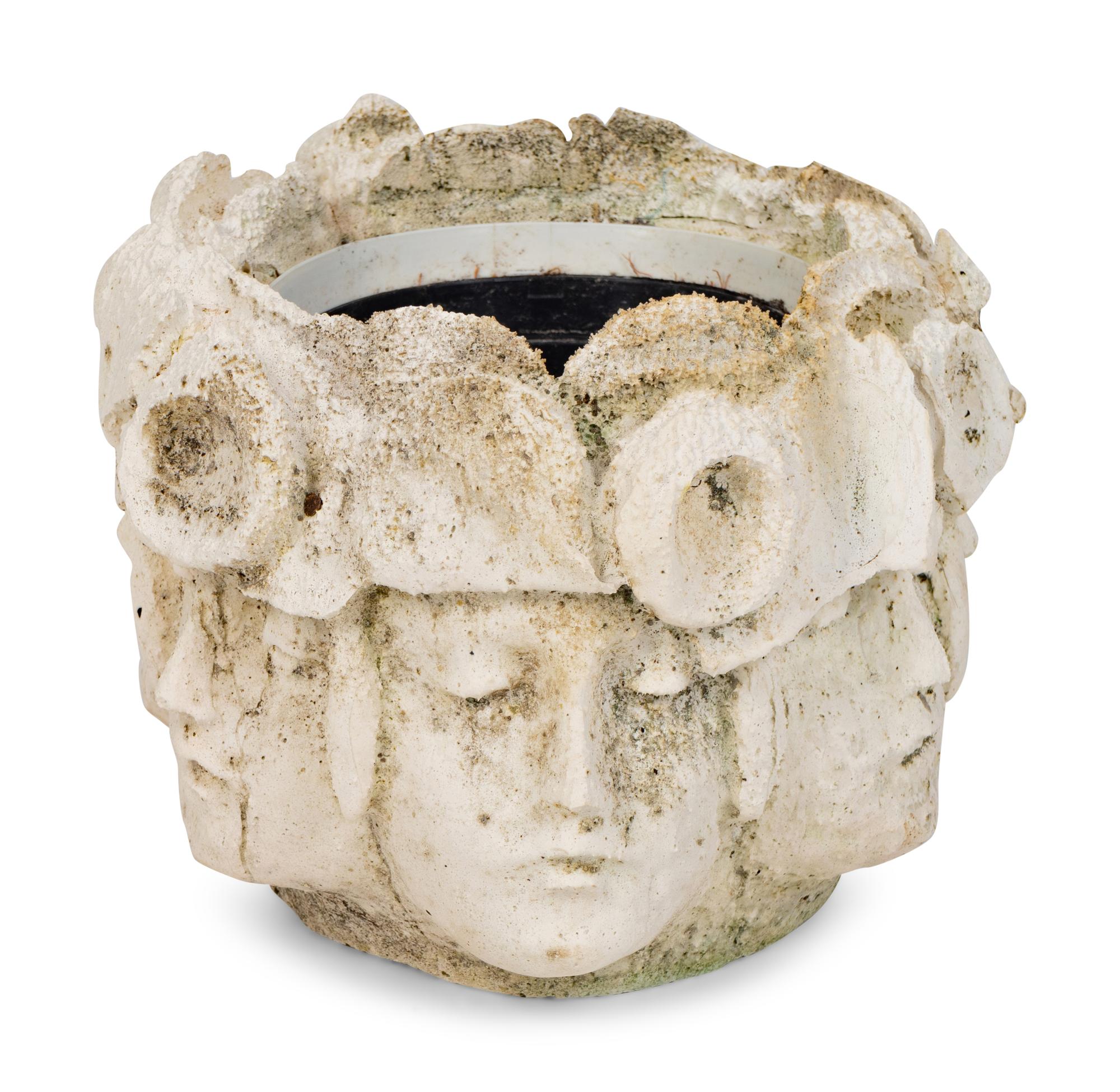A Cast Concrete Jardinière with Faces in Relief