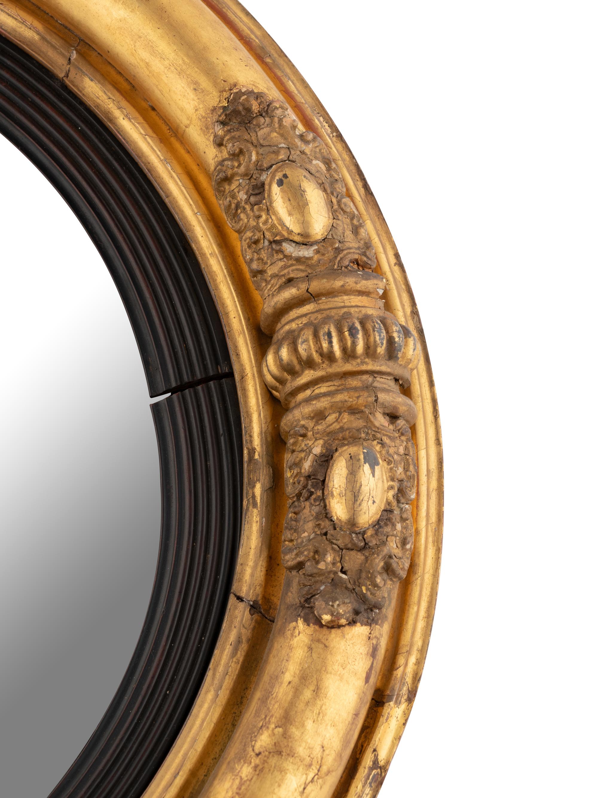 A Classical Carved Giltwood and Gesso Bull's Eye Mirror