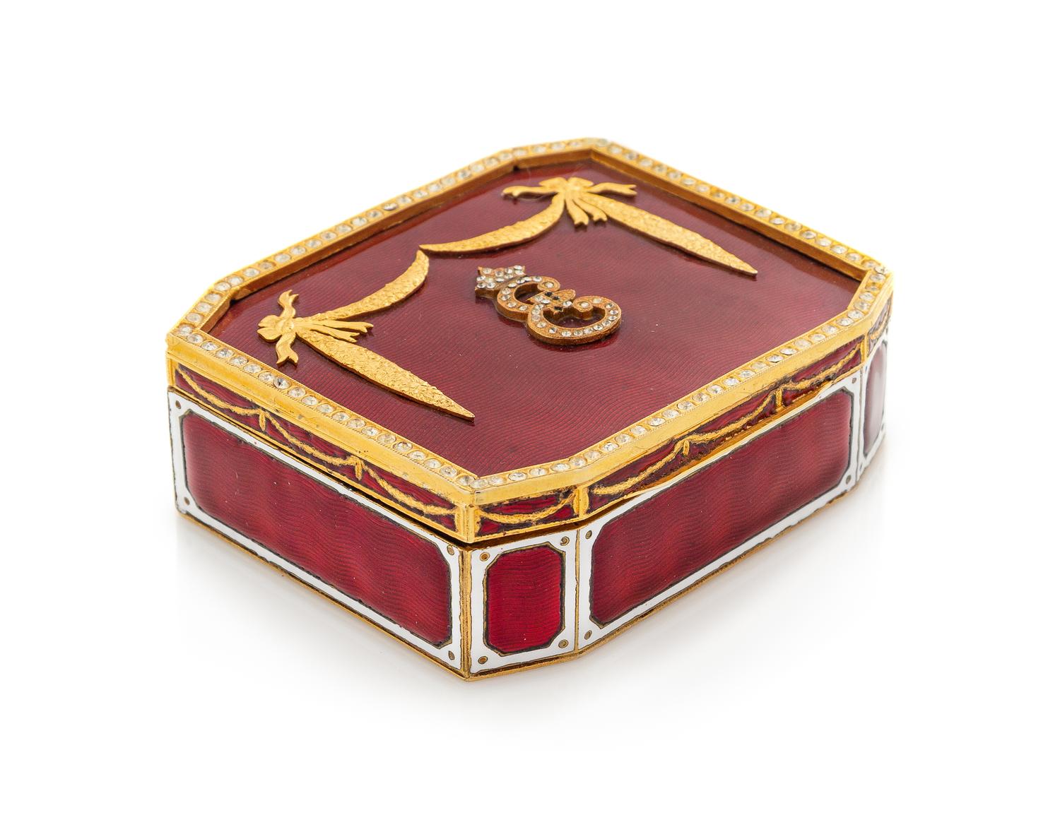 A Continental Gilt Metal and Enamel Table Casket, 20th Century, the case with applied paste stones and centered by a monogram.