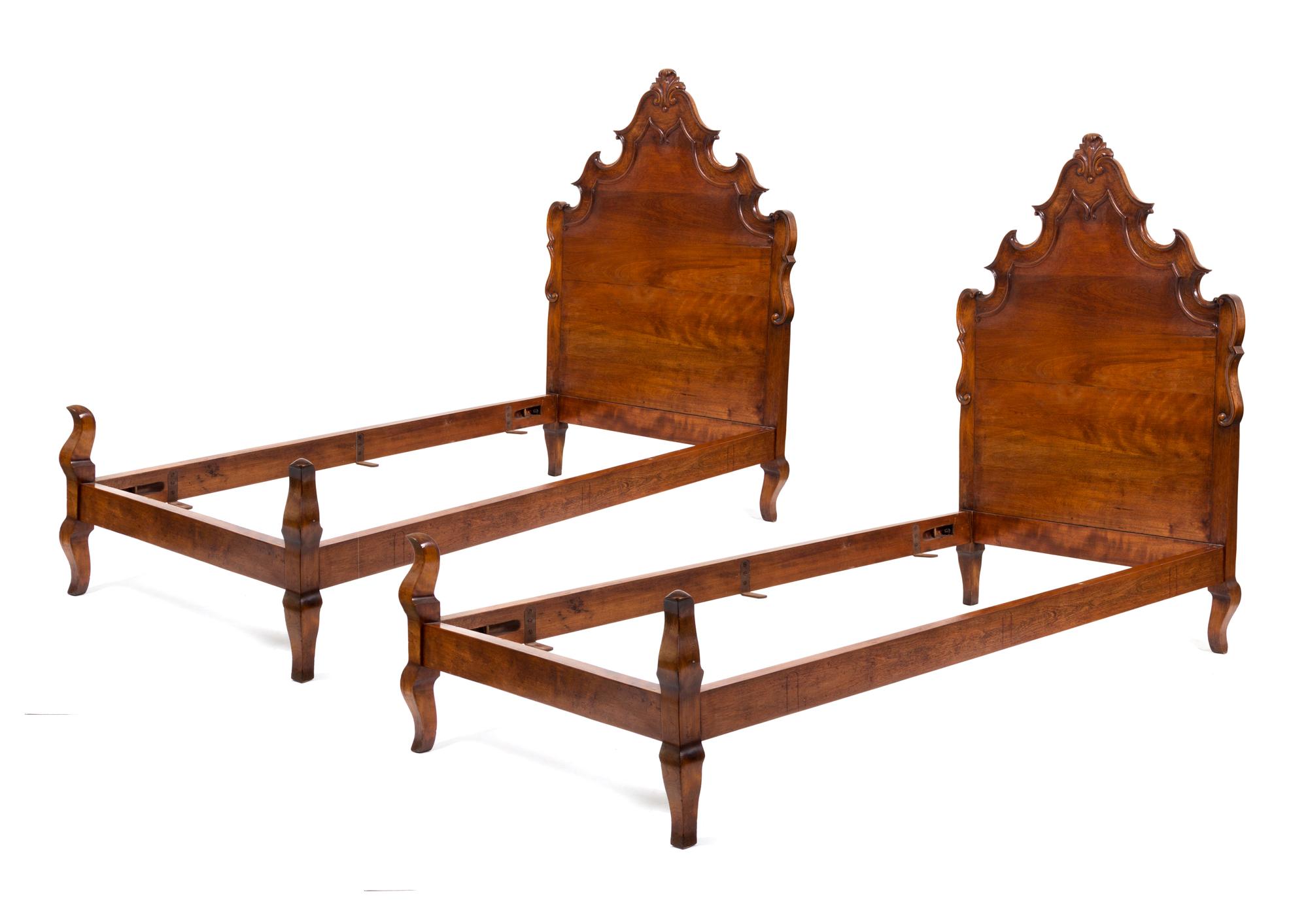 A Pair of Venetian Style Walnut Twin Beds Height 58 x width 39 x depth 73 inches.