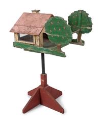 A Carved and Painted Wood Directional Tree and House Bird Feeder