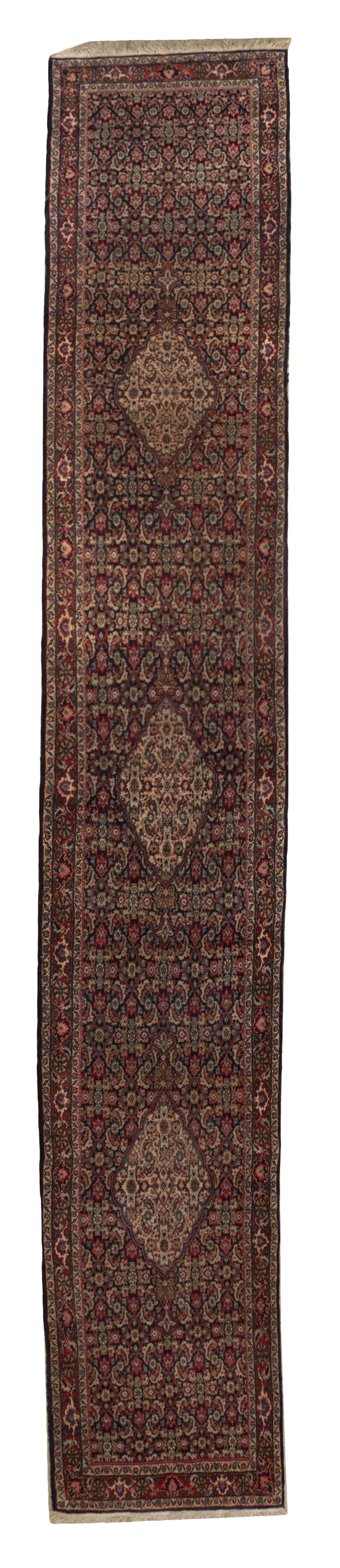 A Persian Wool Runner, 15 feet 6 inches x 2 feet 7 1/2 inches