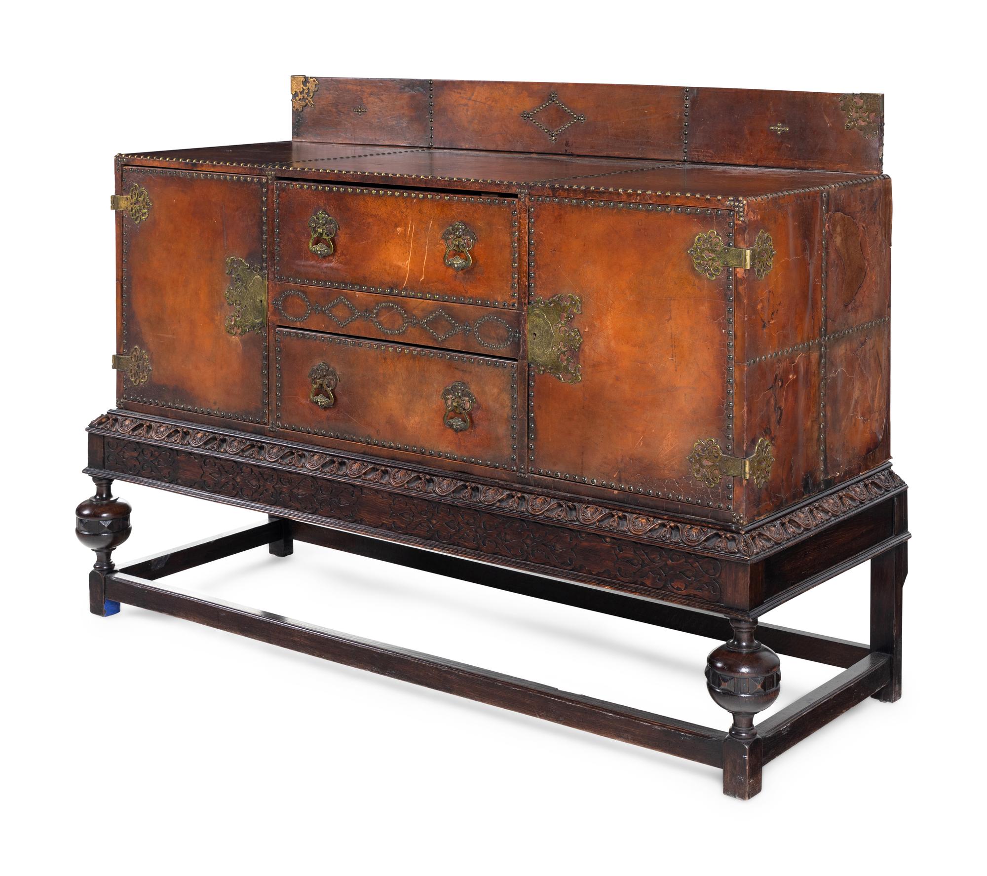 A Spanish Baroque Style Leather-Veneered Side Cabinet