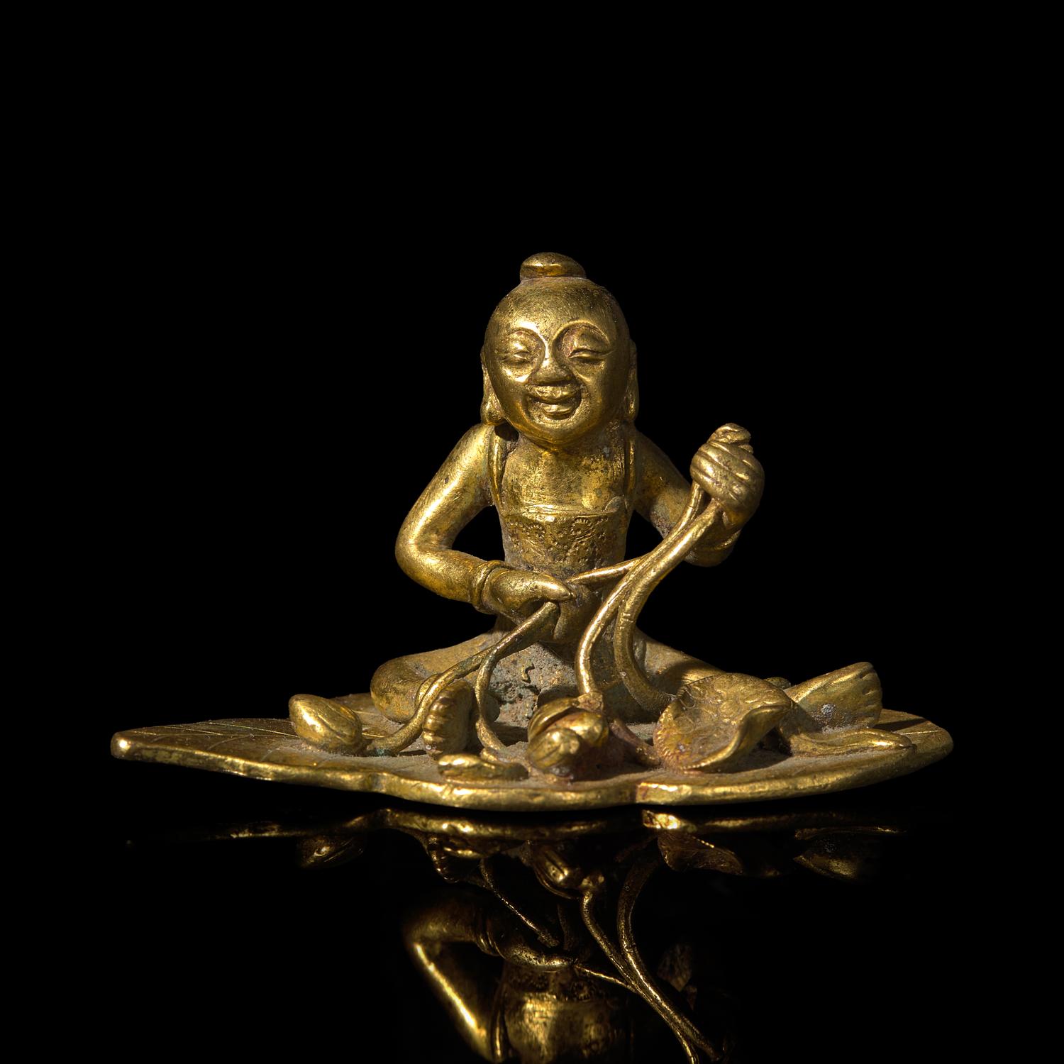 A Small Chinese Bronze Figure of a Boy with Lotus, Qing Dynasty — 清 銅鎏金荷葉童子