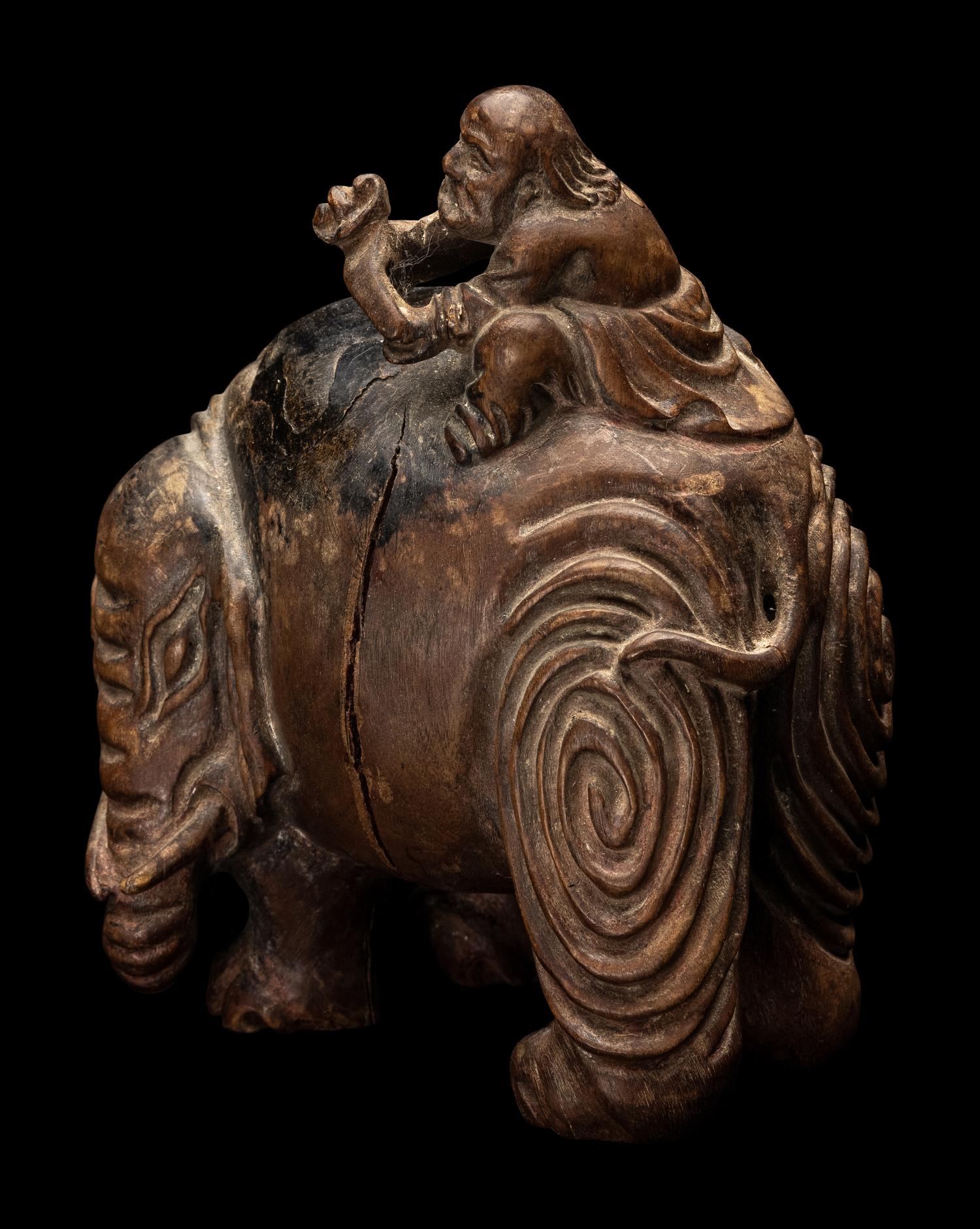 A Chinese Carved Wood 'Foreigner and Elephant' Figural Group