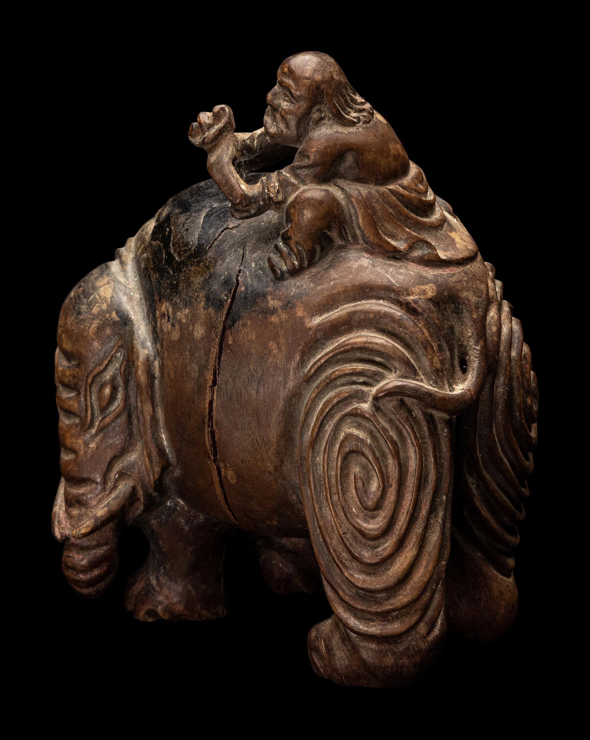A Chinese Carved Wood 'Foreigner and Elephant' Figural Group