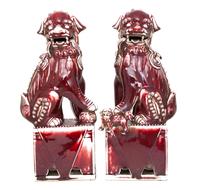 A Pair of Chinese Sang de Boeuf Glazed Pottery Fu Lions Height 16 inches. — 20TH CENTURY