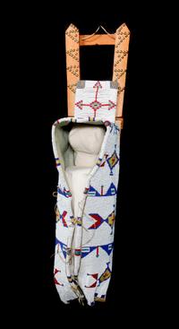 A Sioux Beaded Cradleboard Height 36 x width 9 1/4 inches. — FIRST QUARTER 20TH CENTURY
