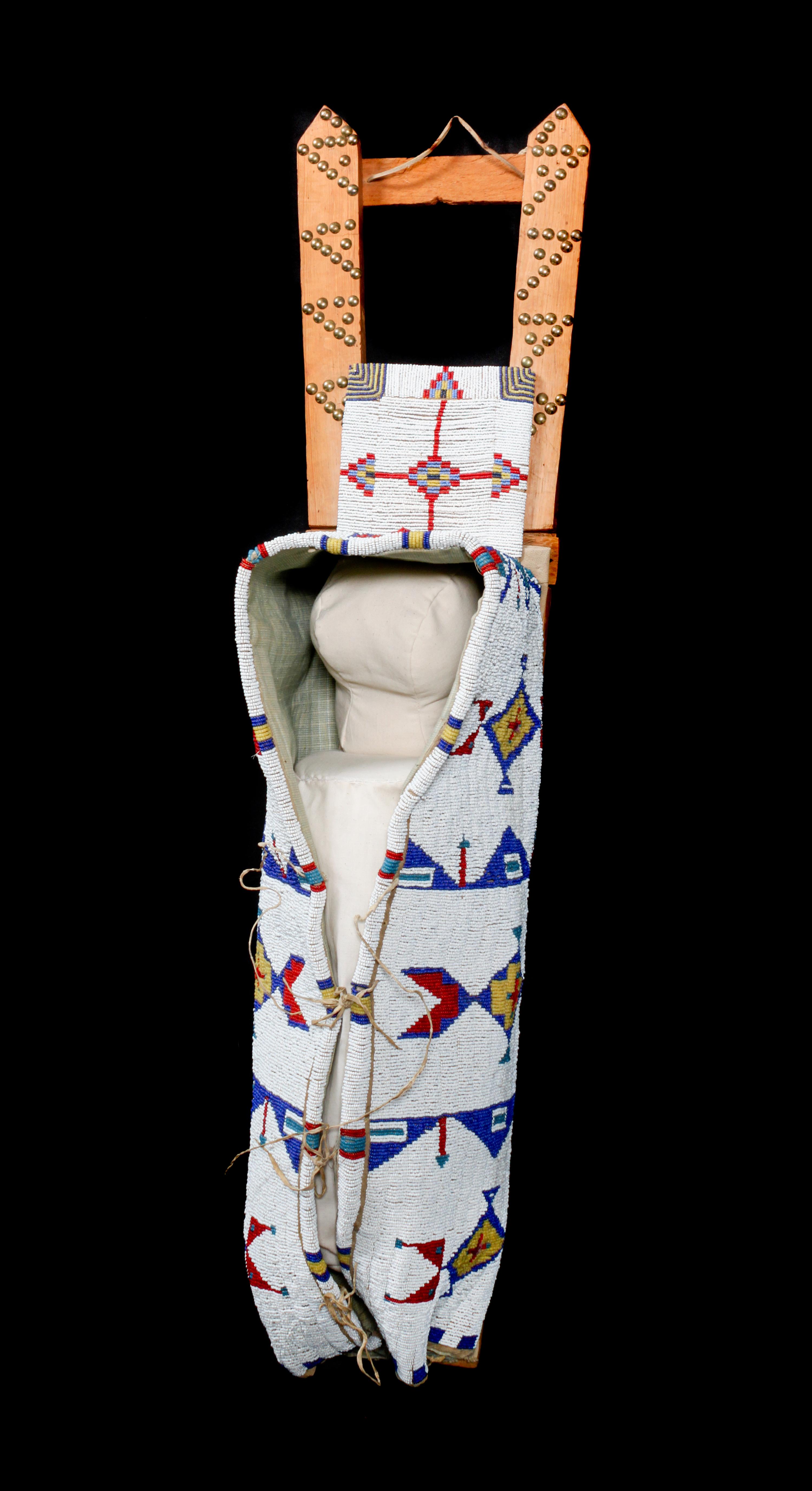 A Sioux Beaded Cradleboard Height 36 x width 9 1/4 inches. — FIRST QUARTER 20TH CENTURY