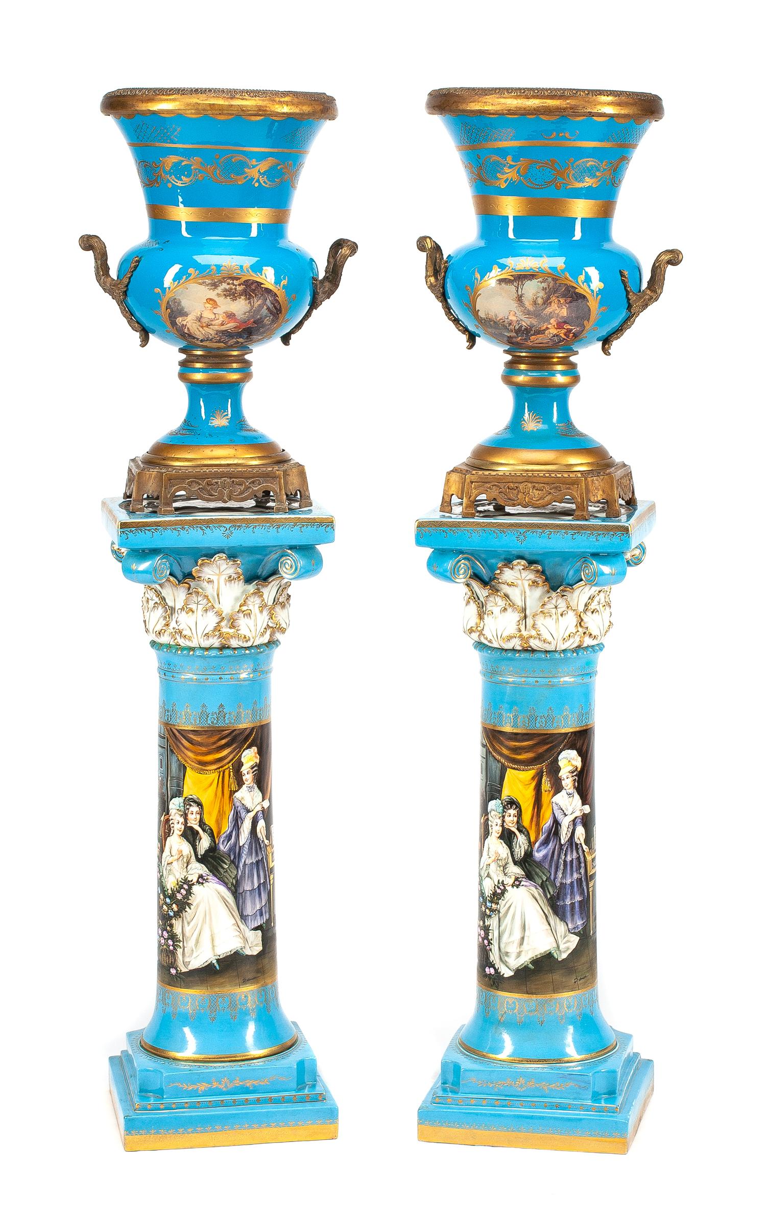 A Pair of Large Gilt Bronze Mounted Sevres Style Porcelain Urns with Pedestals Height of urn 24 1/2 inches; height of pedestal 36 inche
