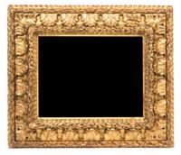 An Italian Carved Giltwood Mirror Height 31 x width 35 1/4 inches, mirror 19 1/2 x 24 3/4 inches.