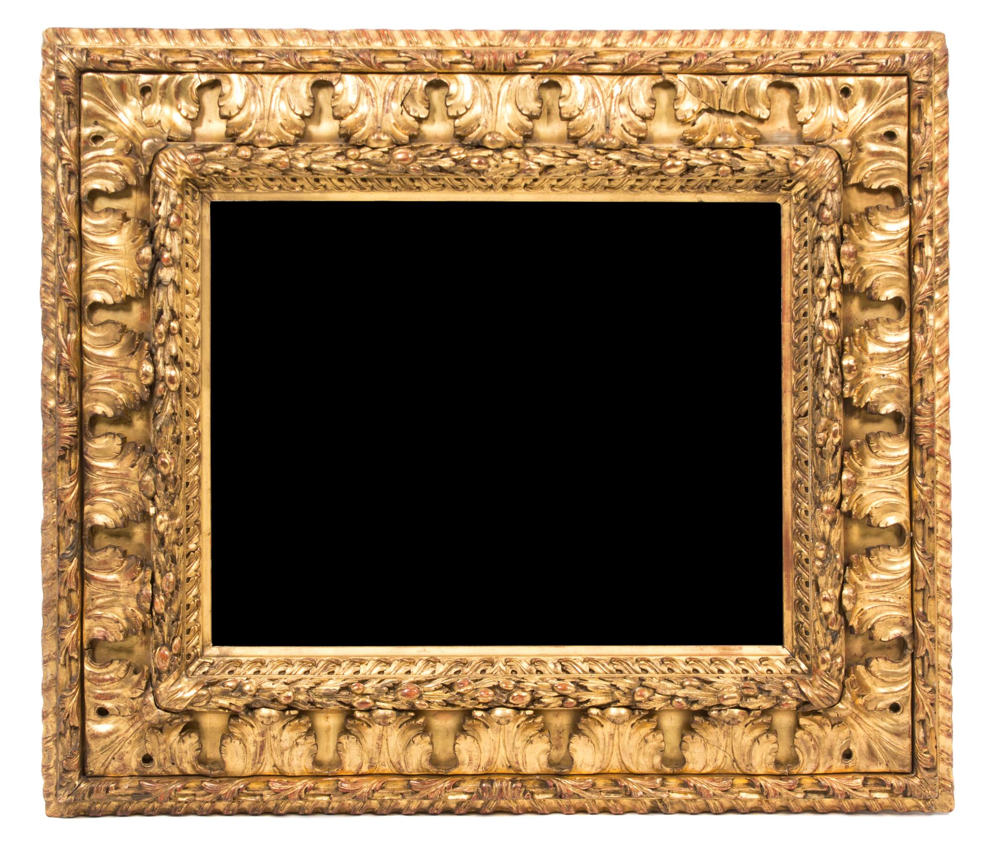 An Italian Carved Giltwood Mirror Height 31 x width 35 1/4 inches, mirror 19 1/2 x 24 3/4 inches.