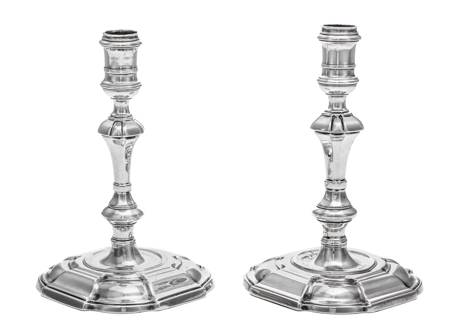 A Near Pair of George II Silver Candlesticks, James Gould, London, 1727 and 1736, each having a banded candle cup above a faceted, knop