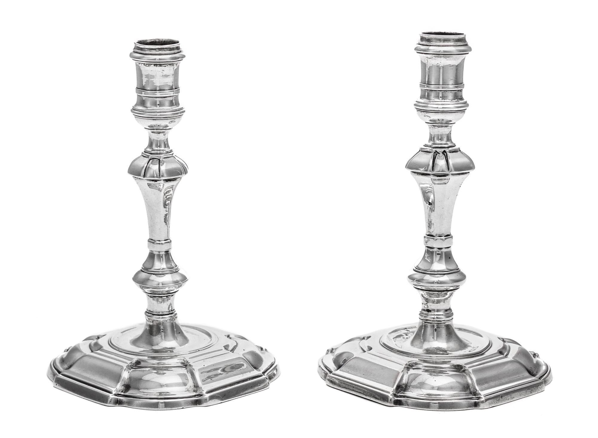 A Near Pair of George II Silver Candlesticks, James Gould, London, 1727 and 1736, each having a banded candle cup above a faceted, knop