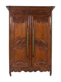 A Louis XV Provincial Brass Mounted Carved Oak Armoire