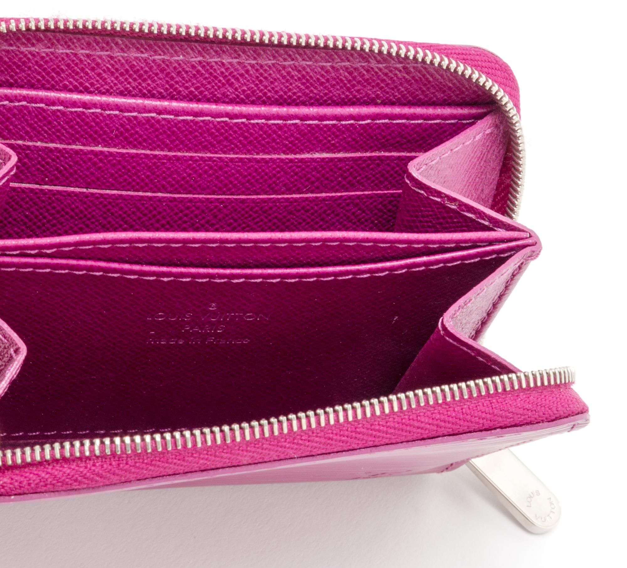 A Louis Vuitton Fuschia Epi Zippy Coin Purse, 4.3"x 3.3" x 0.8".