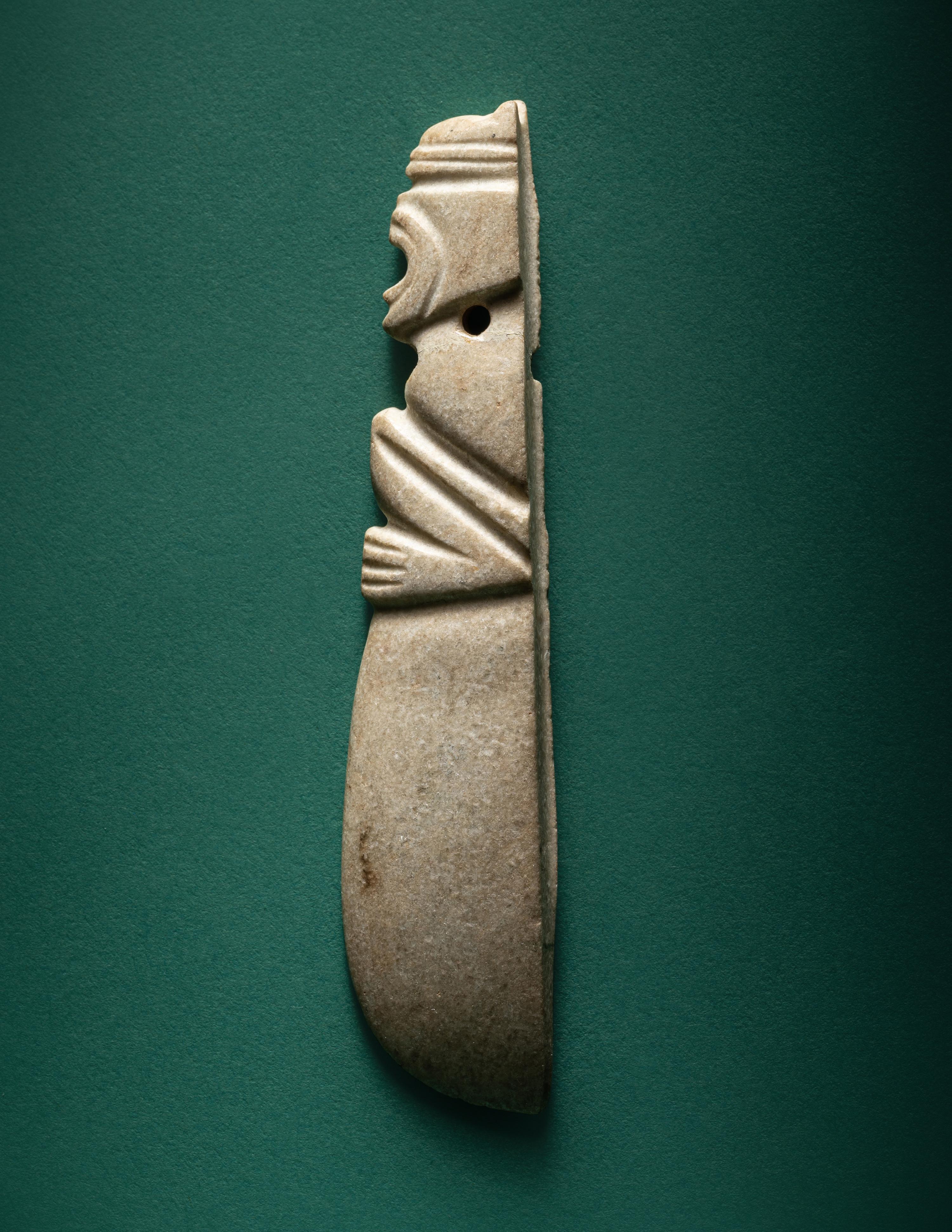 A Costa Rican White Jade Axe Pendant of a Crouching Monkey