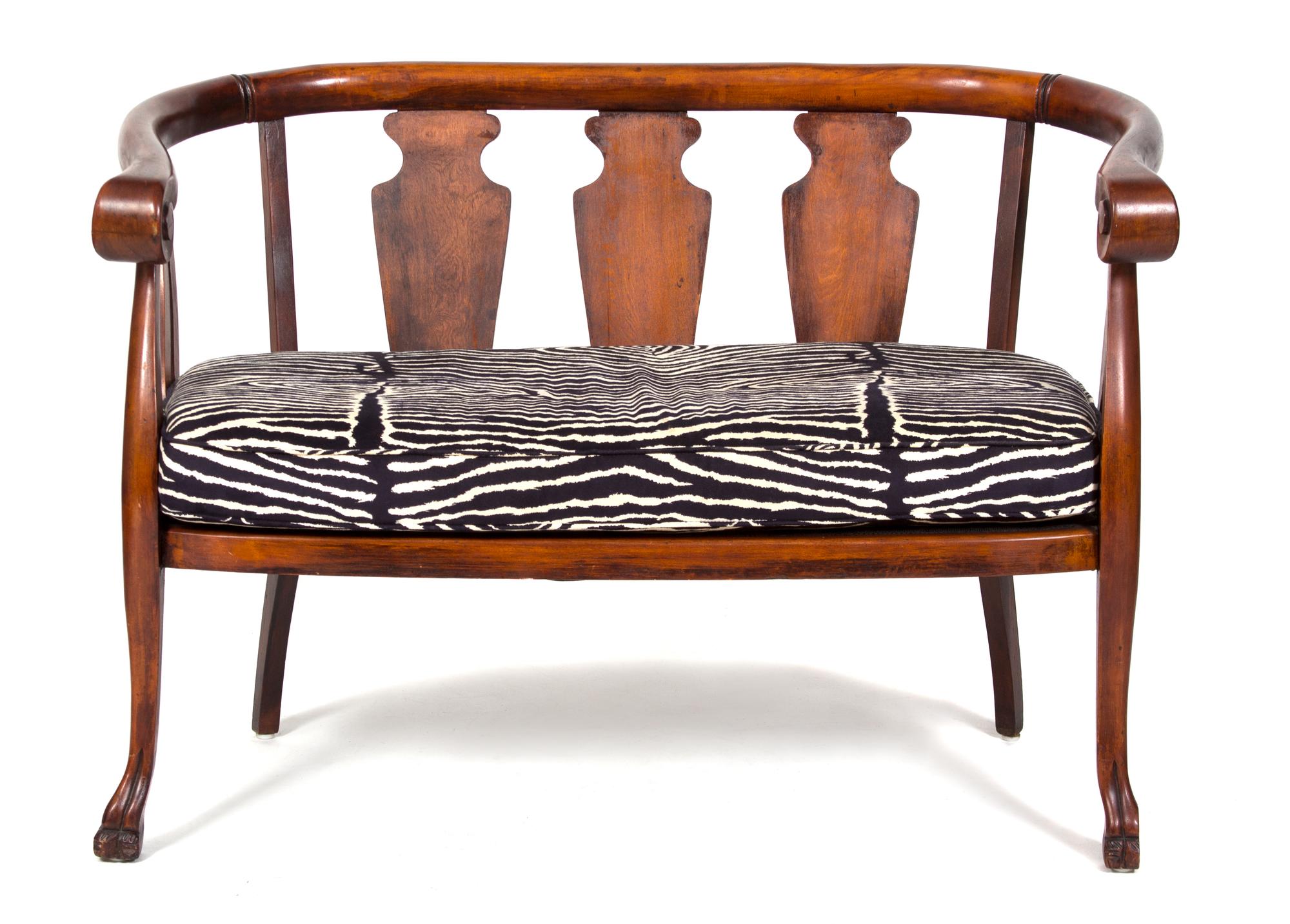 A British Colonial Mahogany Loveseat and Barrel-Back Rocking Chair Height of loveseat 32 x width 45 x depth 23 inches. — 20TH CENTURY