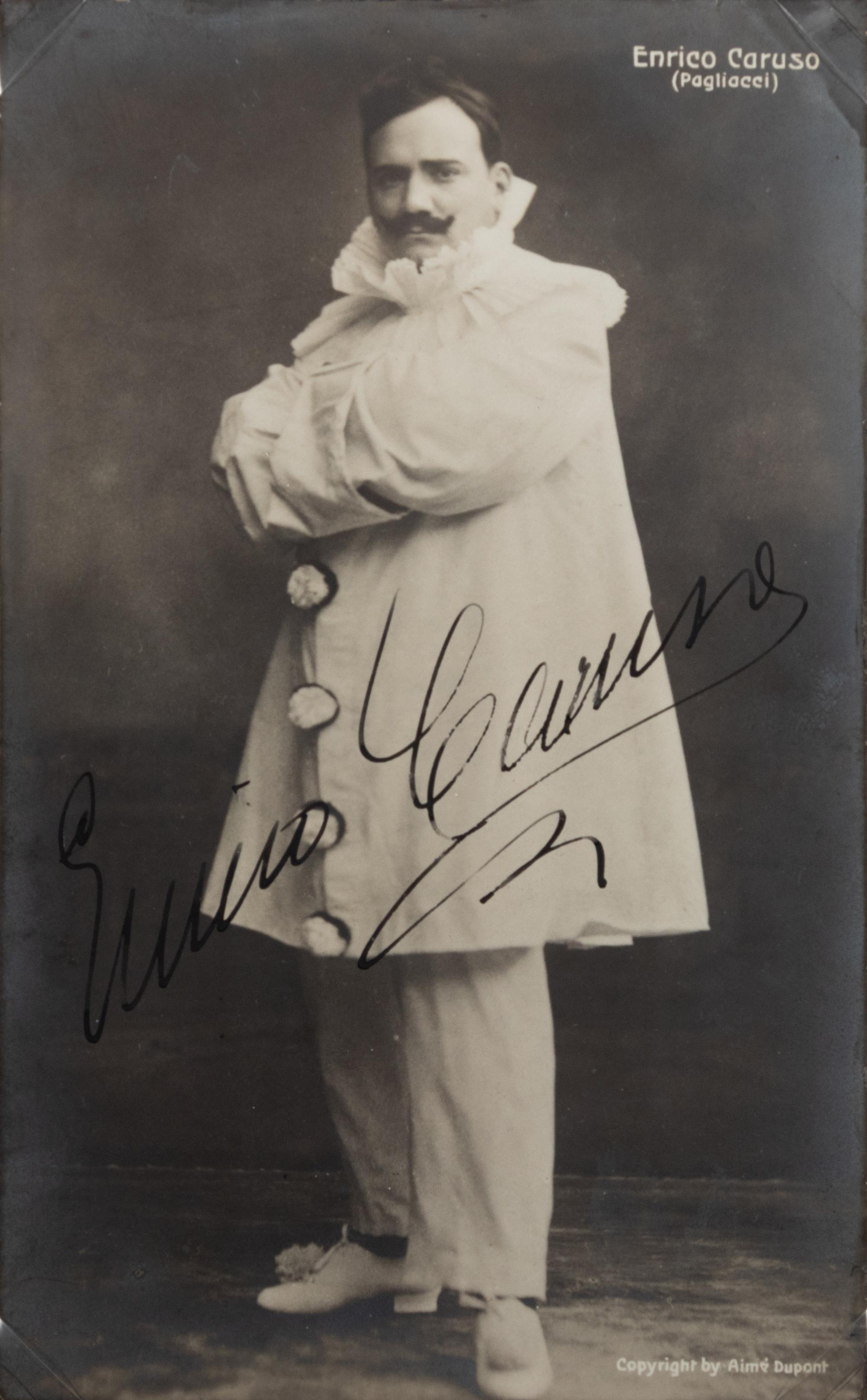 CARUSO, Enrico (1873-1921). Black and white photograph as Canio in Pagliacci , signed ("Enrico Caruso"), by Aime Dupont, n.d.