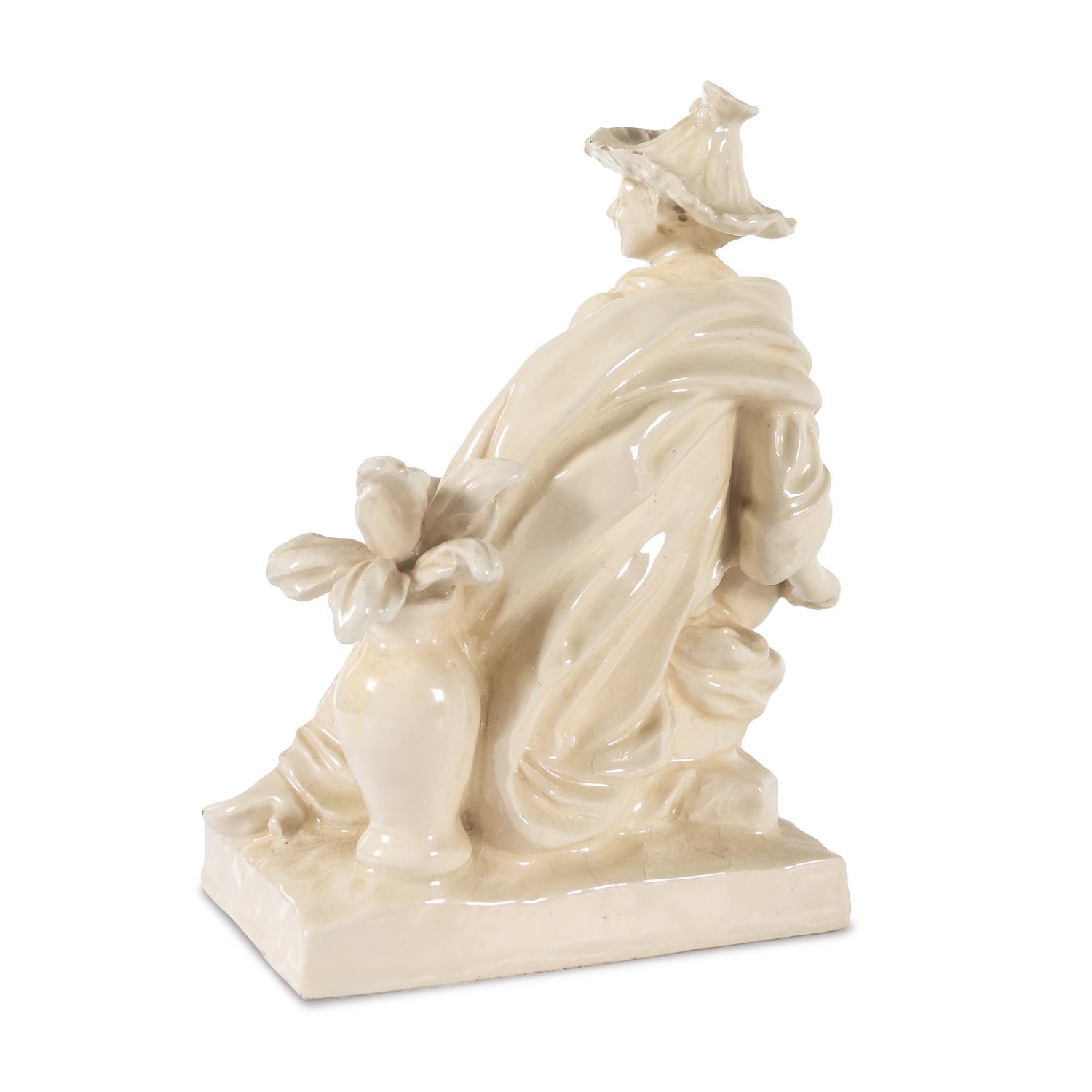 A French White Glazed Faience Chinoiserie Figure