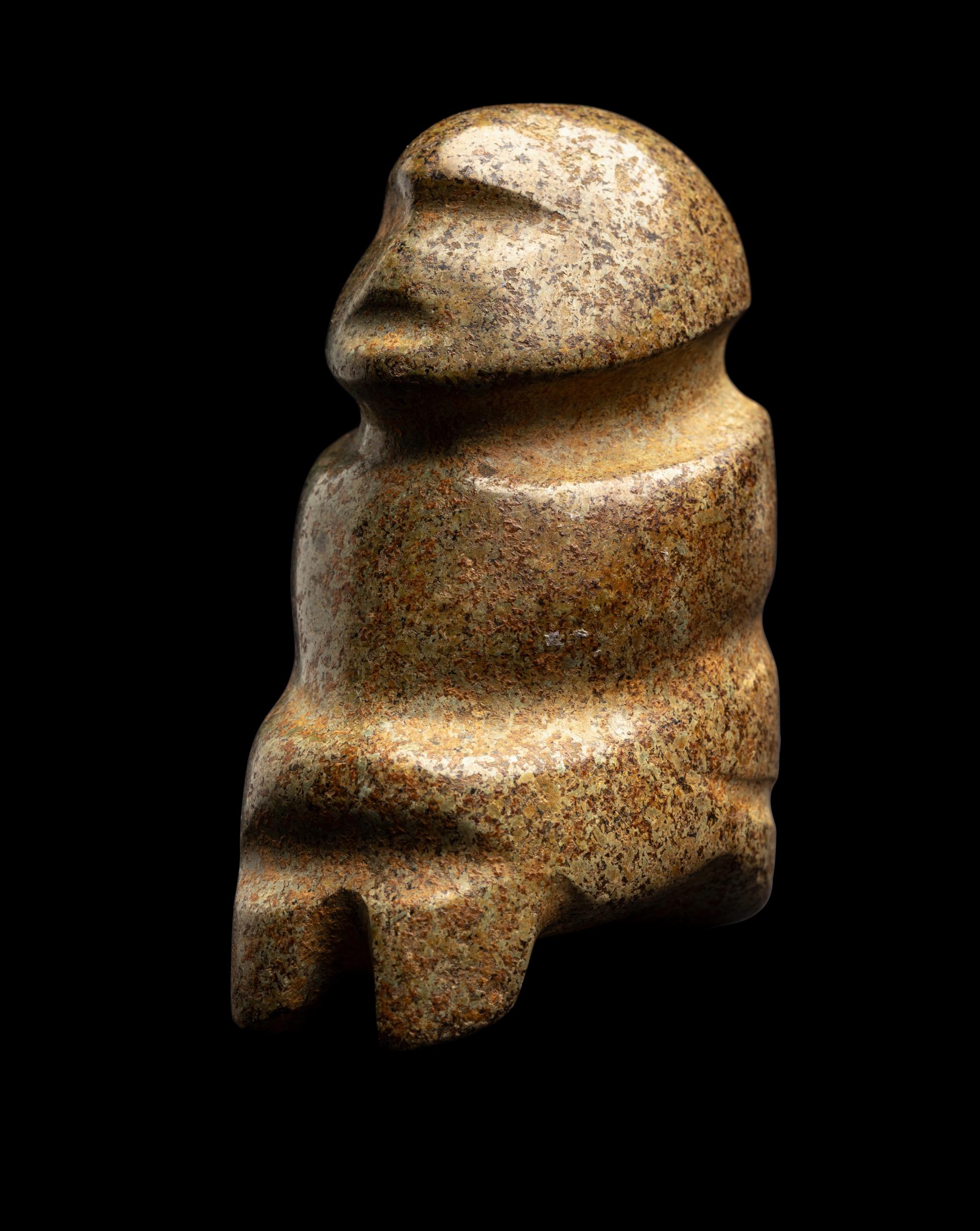 A Mezcala Green-White Stone Seated Figure