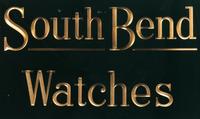 A Reverse Paint and Parcel Gilt South Bend Watches Advertising Sign