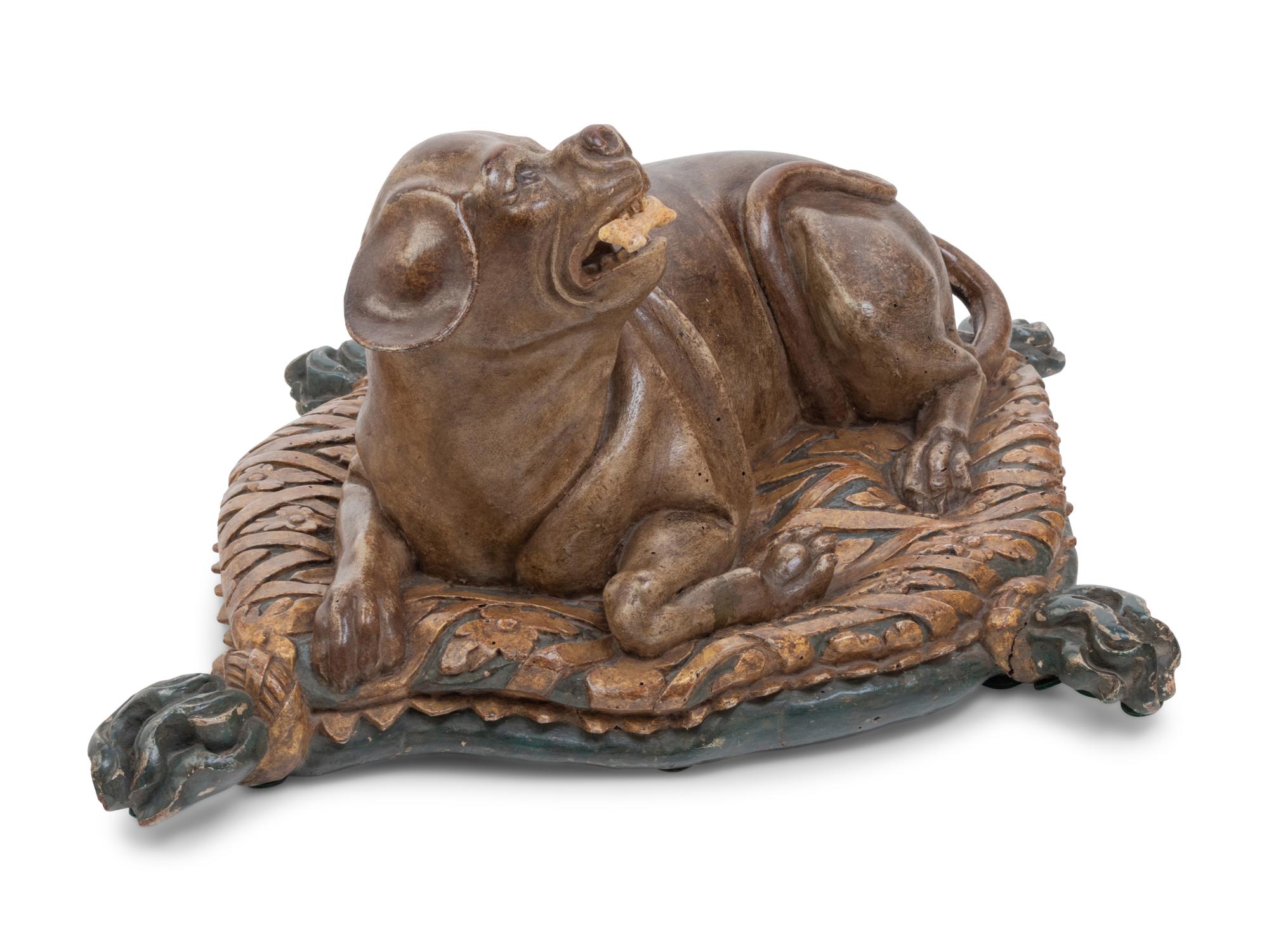 An Italian Carved and Painted Model of a Recumbent Dog