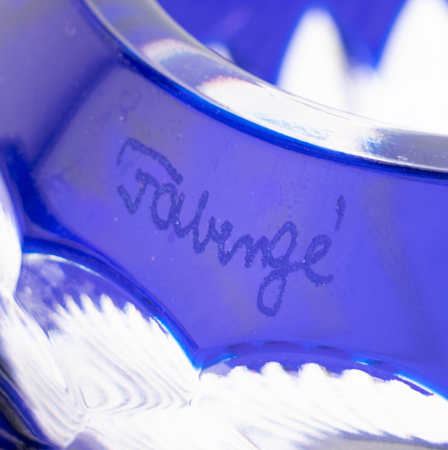 A Set of Four Modern Fabergé Blue Cut-to-Clear Glass Votive Holders and a John Hardy Silver Snuffer