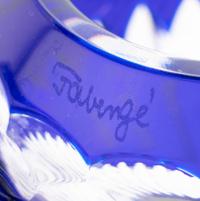 A Set of Four Modern Fabergé Blue Cut-to-Clear Glass Votive Holders and a John Hardy Silver Snuffer