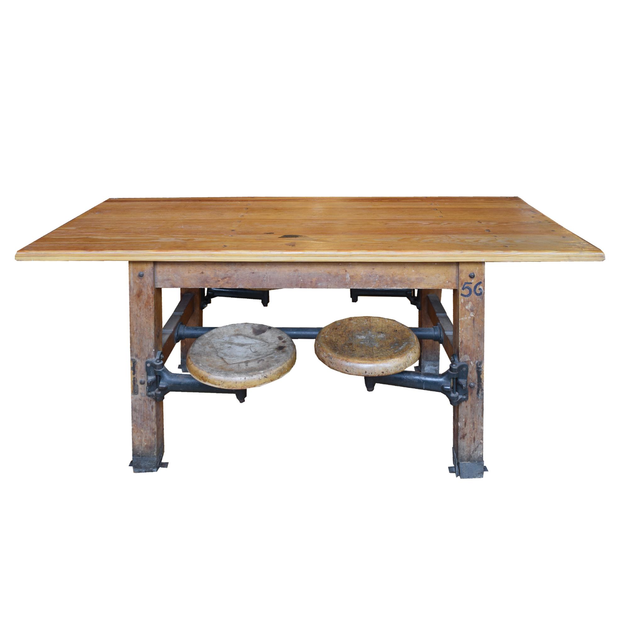 An Industrial Table with Swing Arm Seats 71" W x 29.5" D x 30" H — United States, Circa 1930