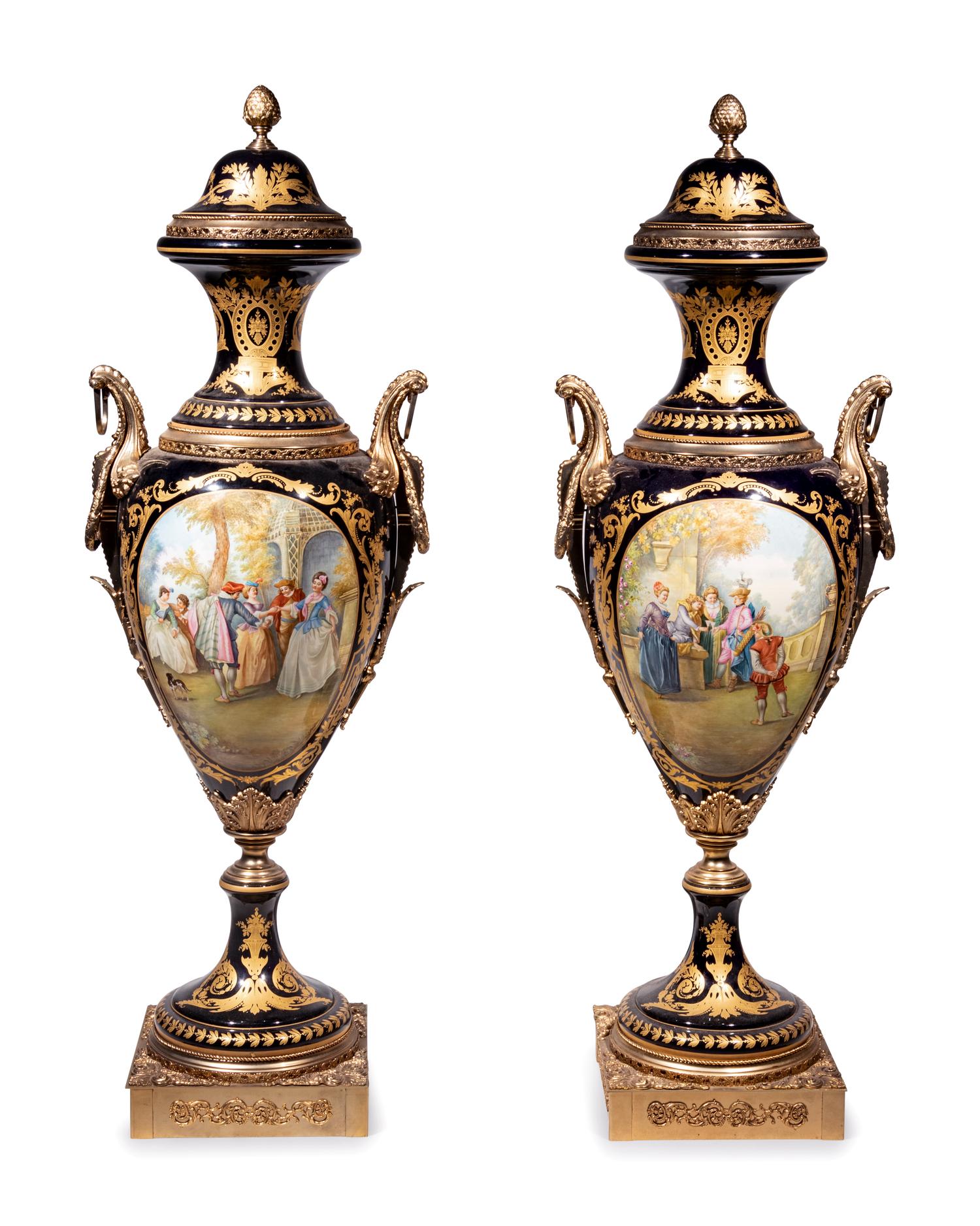 A Pair of Monumental Sèvres Style Gilt Metal Mounted Porcelain Covered Urns on Pedestals