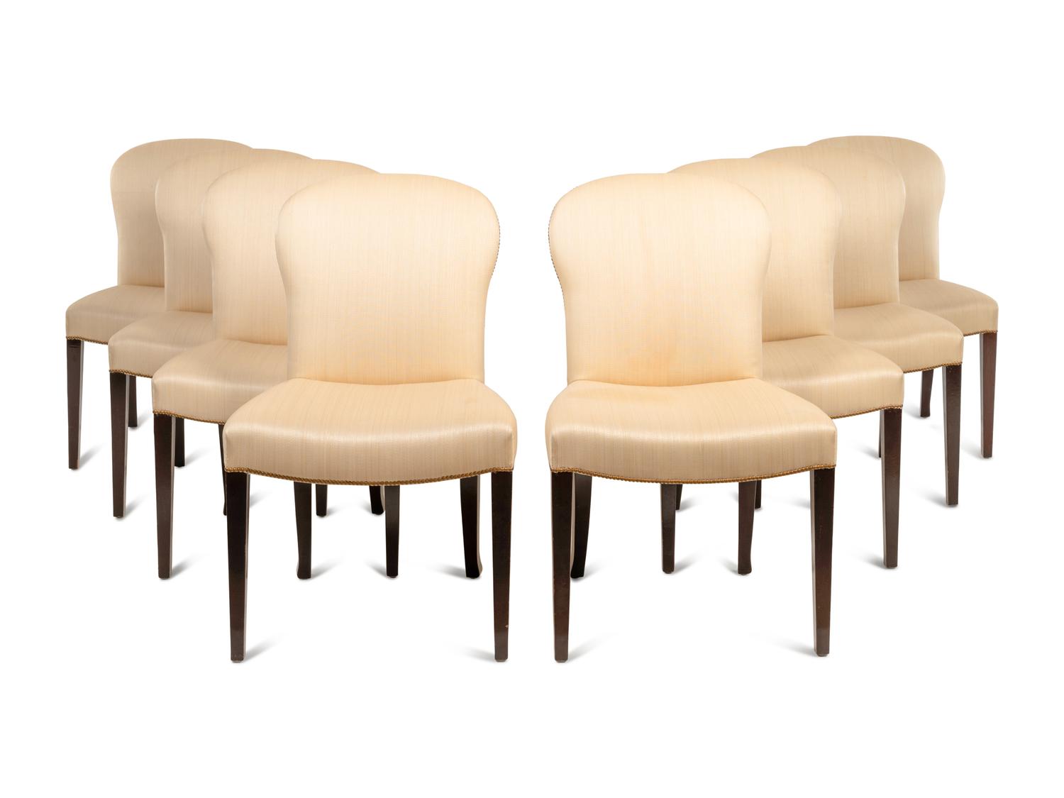 A Set of Eight Saddle Dining Chairs