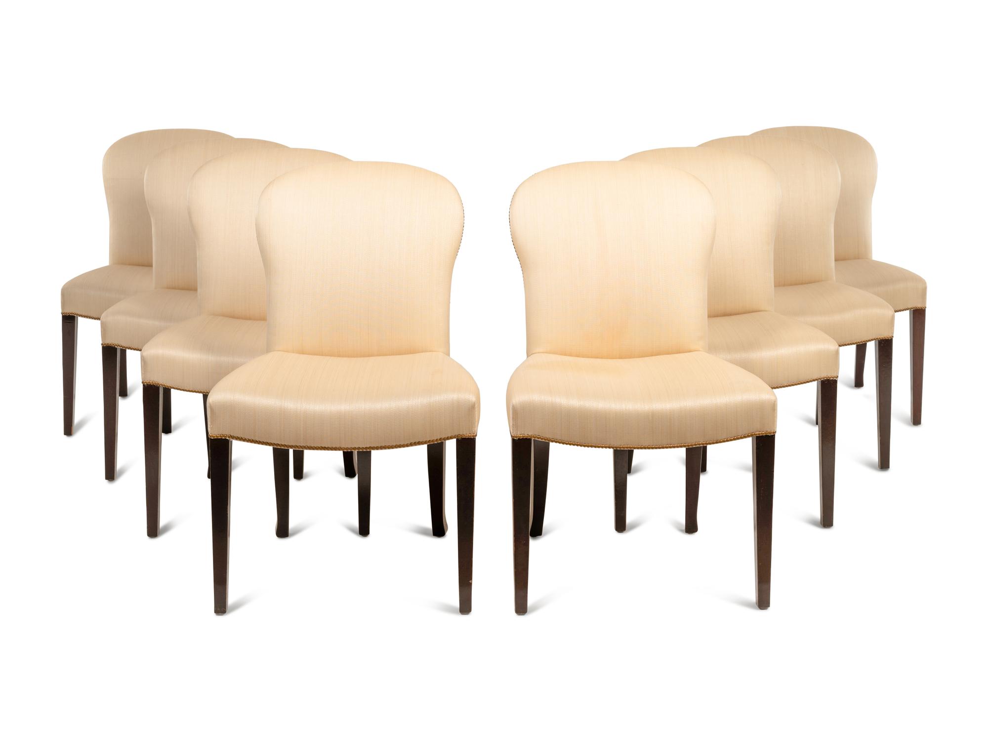 A Set of Eight Saddle Dining Chairs