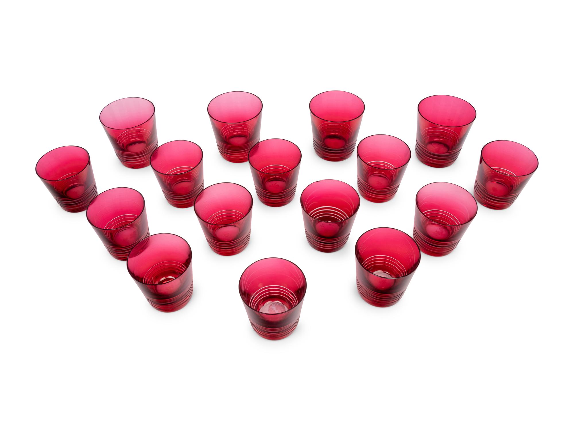 A Set of Sixteen Hermès Attelage Pink Glass Tumblers