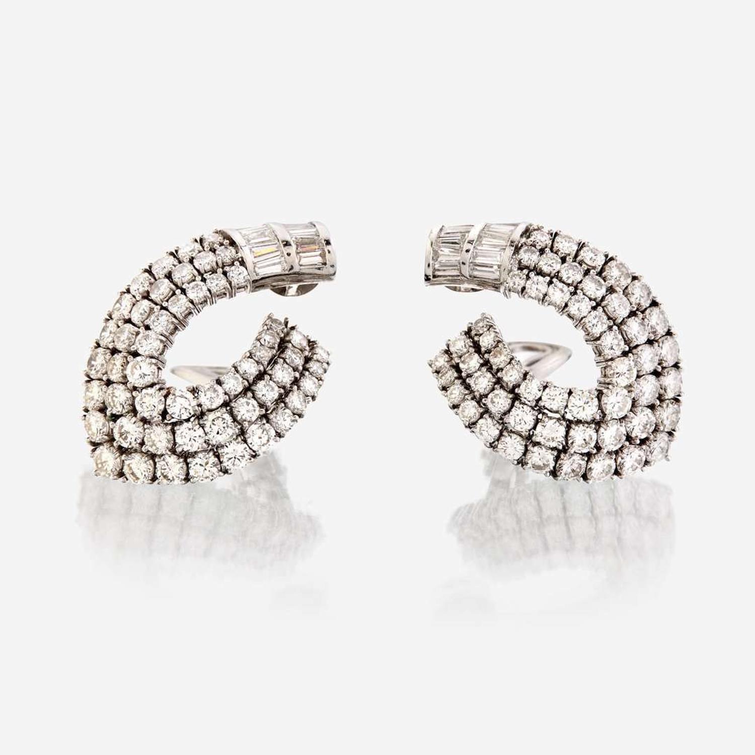 A pair of diamond and eighteen karat white gold ear clips