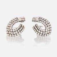 A pair of diamond and eighteen karat white gold ear clips