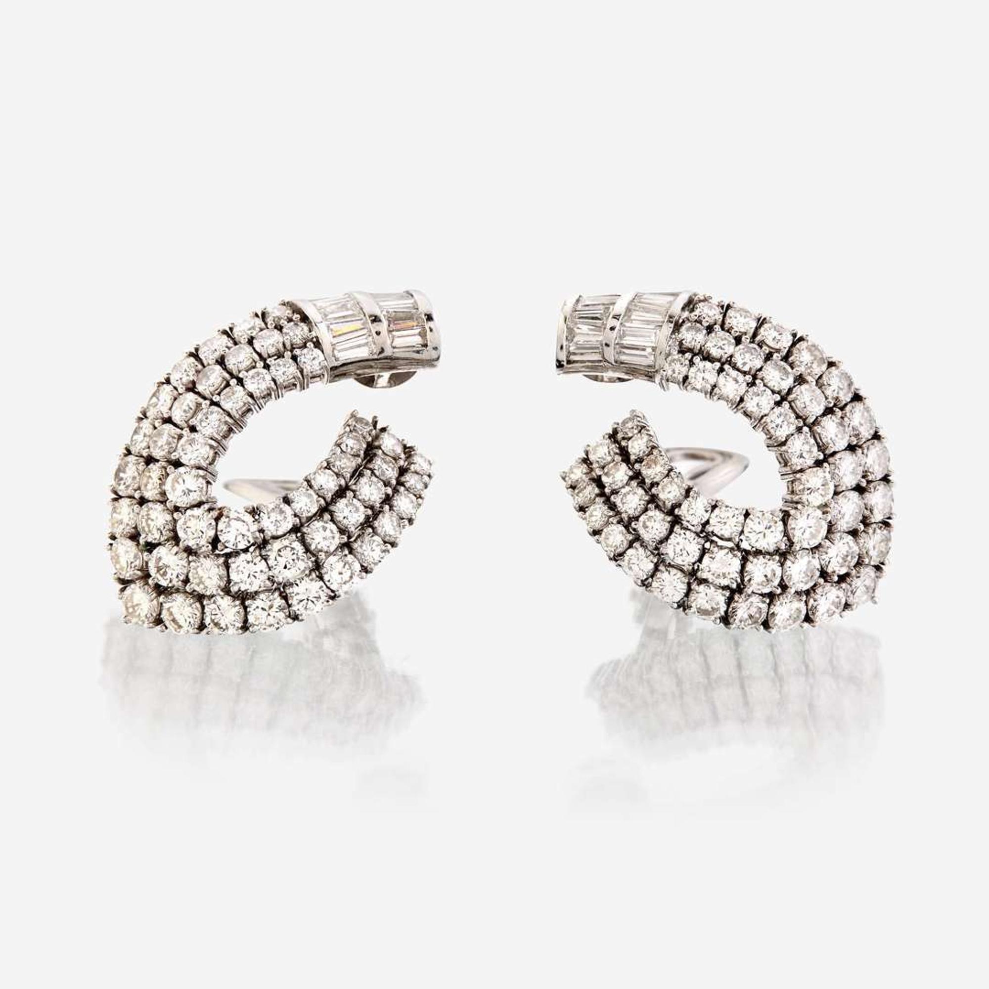 A pair of diamond and eighteen karat white gold ear clips
