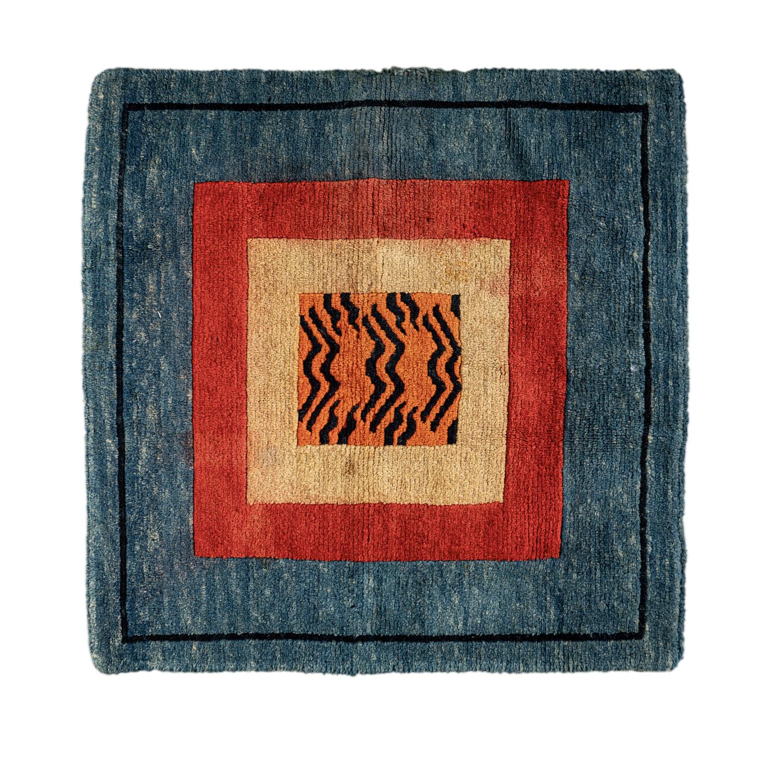 A Tibetan Silk Patchwork Offering Cloth and A Tibetan Rug