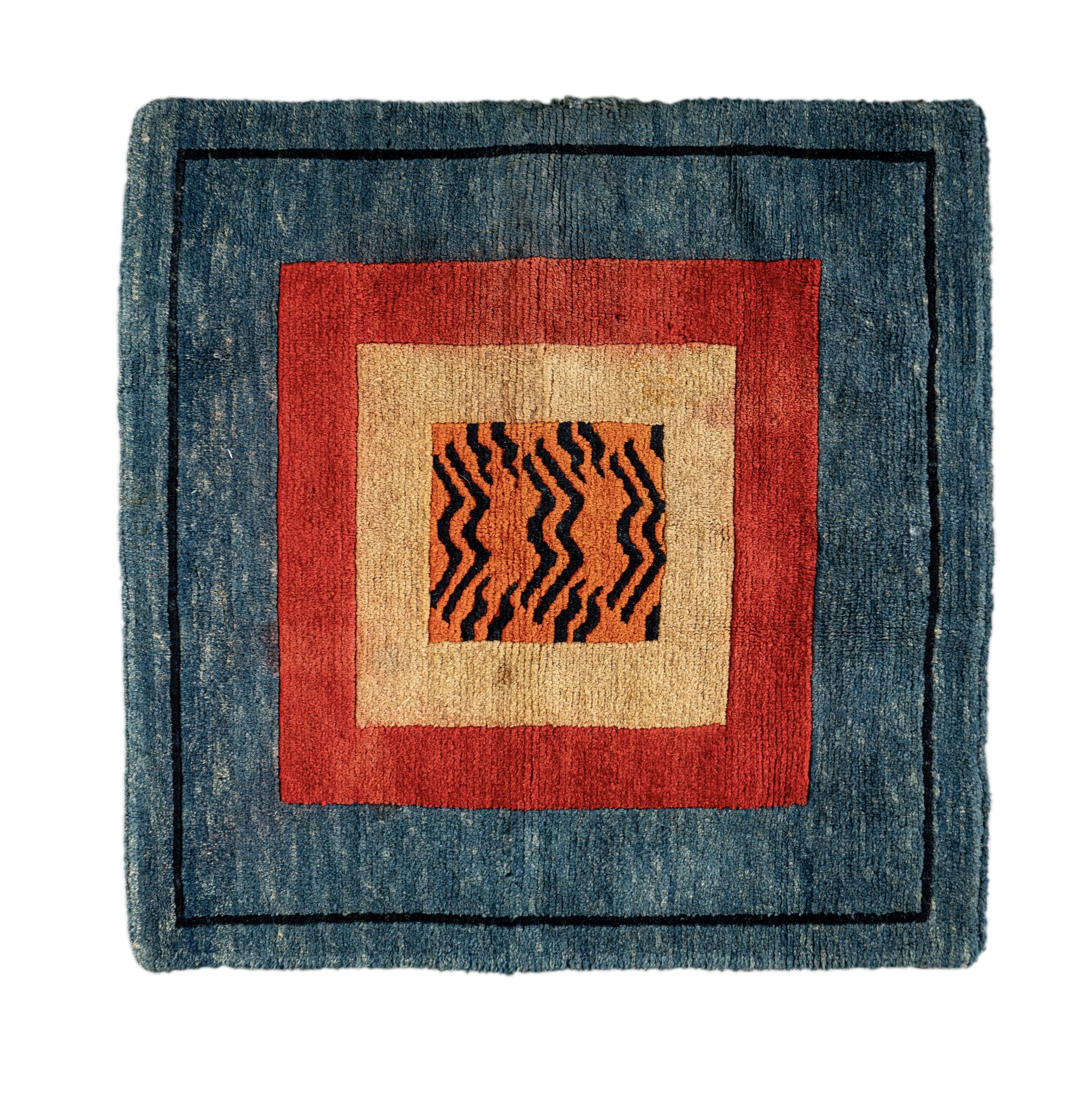 A Tibetan Silk Patchwork Offering Cloth and A Tibetan Rug