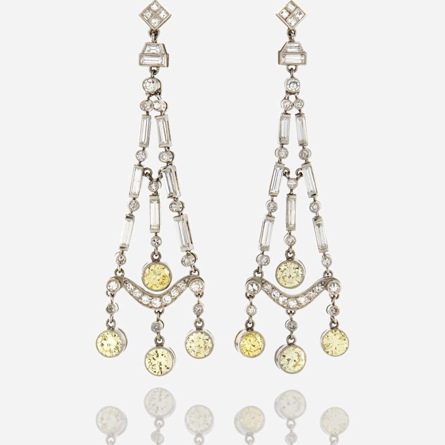 A pair of diamond, colored diamond, and platinum pendant earrings