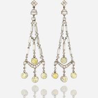 A pair of diamond, colored diamond, and platinum pendant earrings