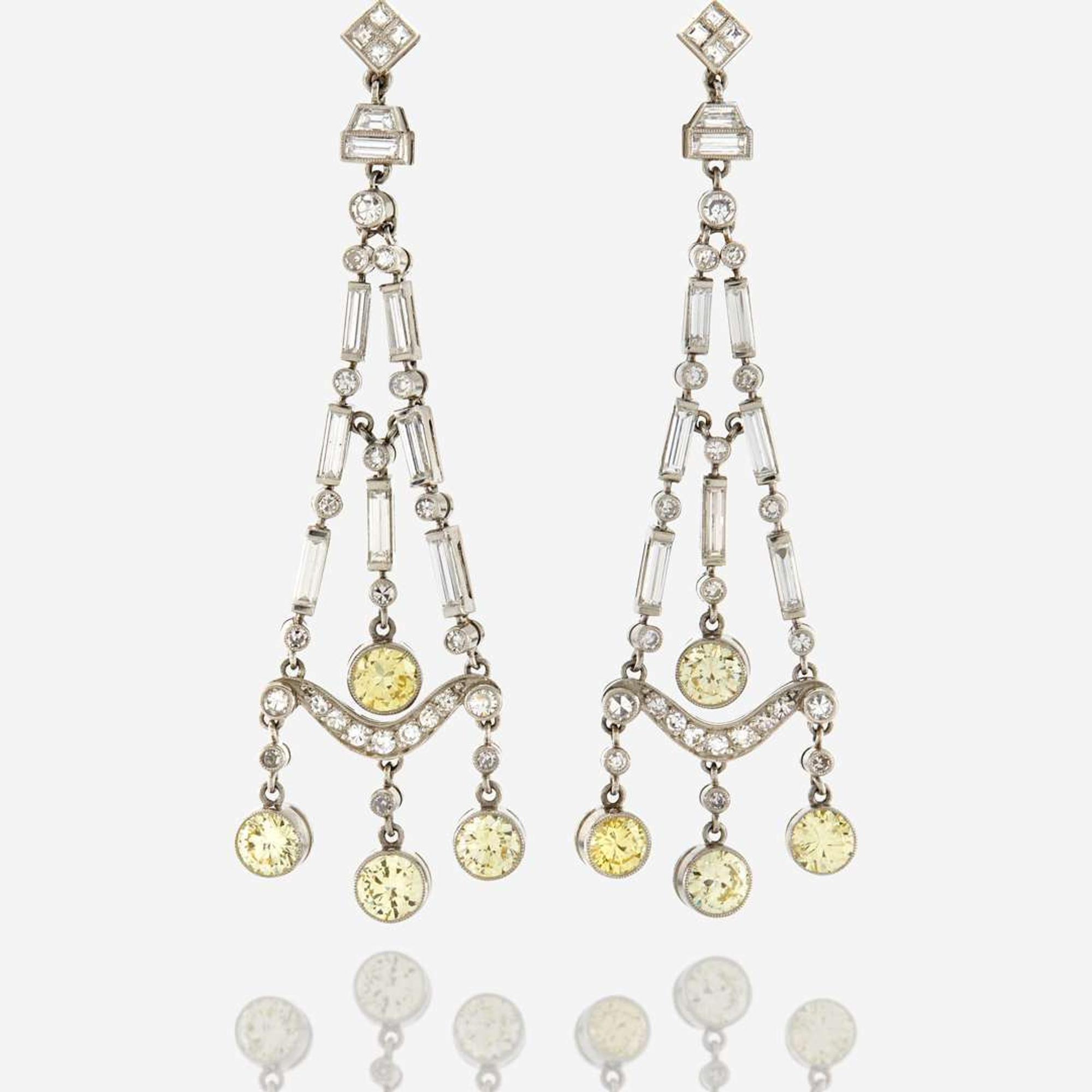 A pair of diamond, colored diamond, and platinum pendant earrings